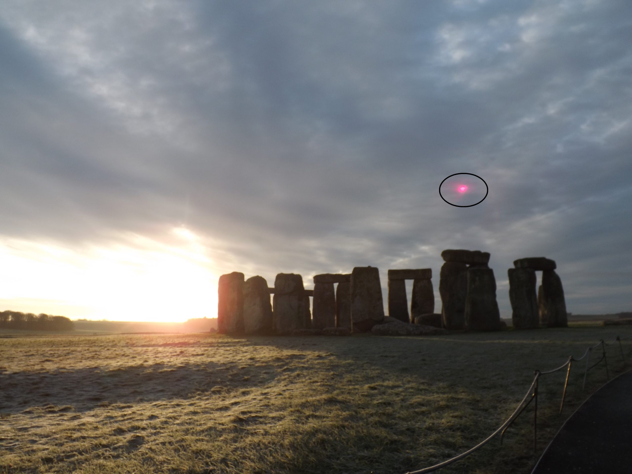 A UFO over Stonehenge. Illustration.
