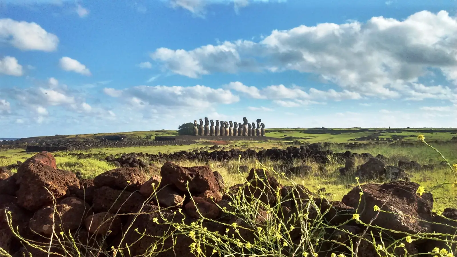 Fifteen moai standing in a row on the restored ceremonial platform of Ahu Tongariki, Rapa Nui.