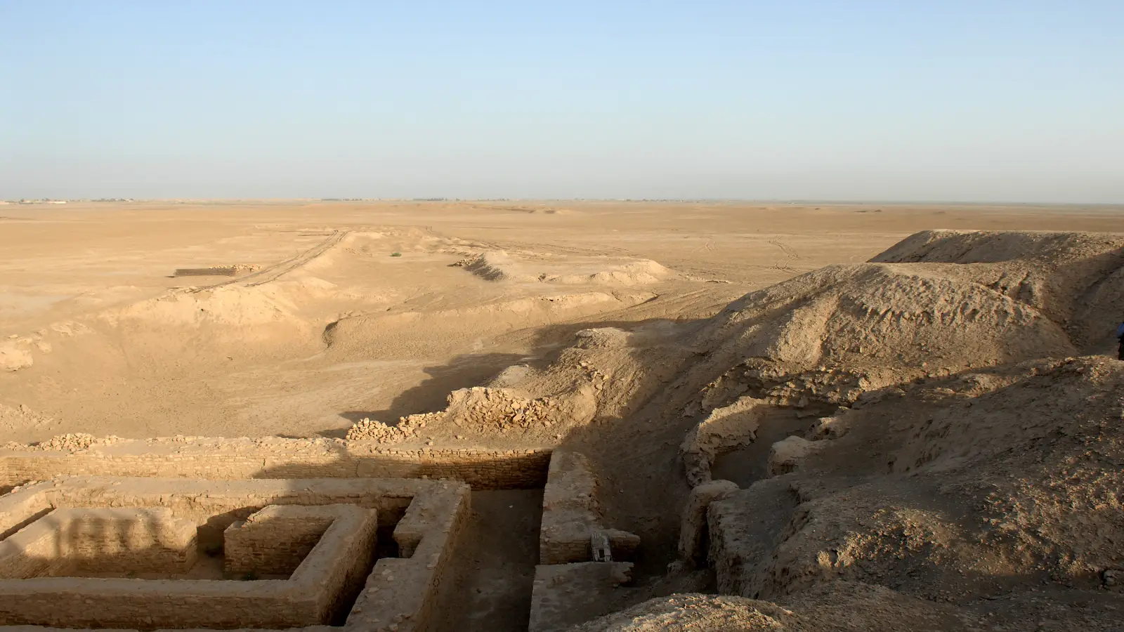 Excavated walls and settlement mounds at Uruk, modern Warka, across the southern Iraqi plain.