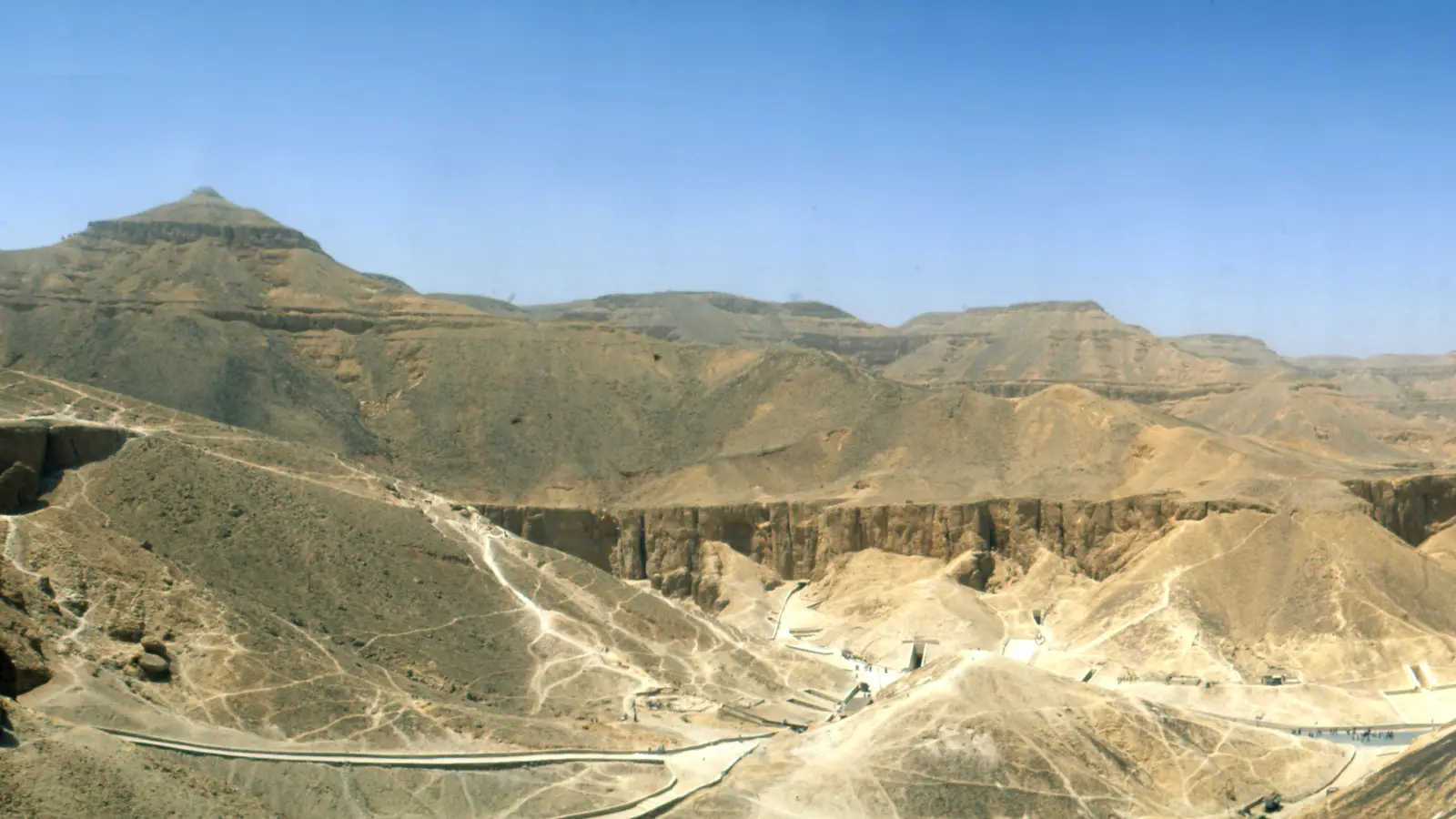 Panoramic view over the desert cliffs and tomb entrances of the Valley of the Kings near Luxor.