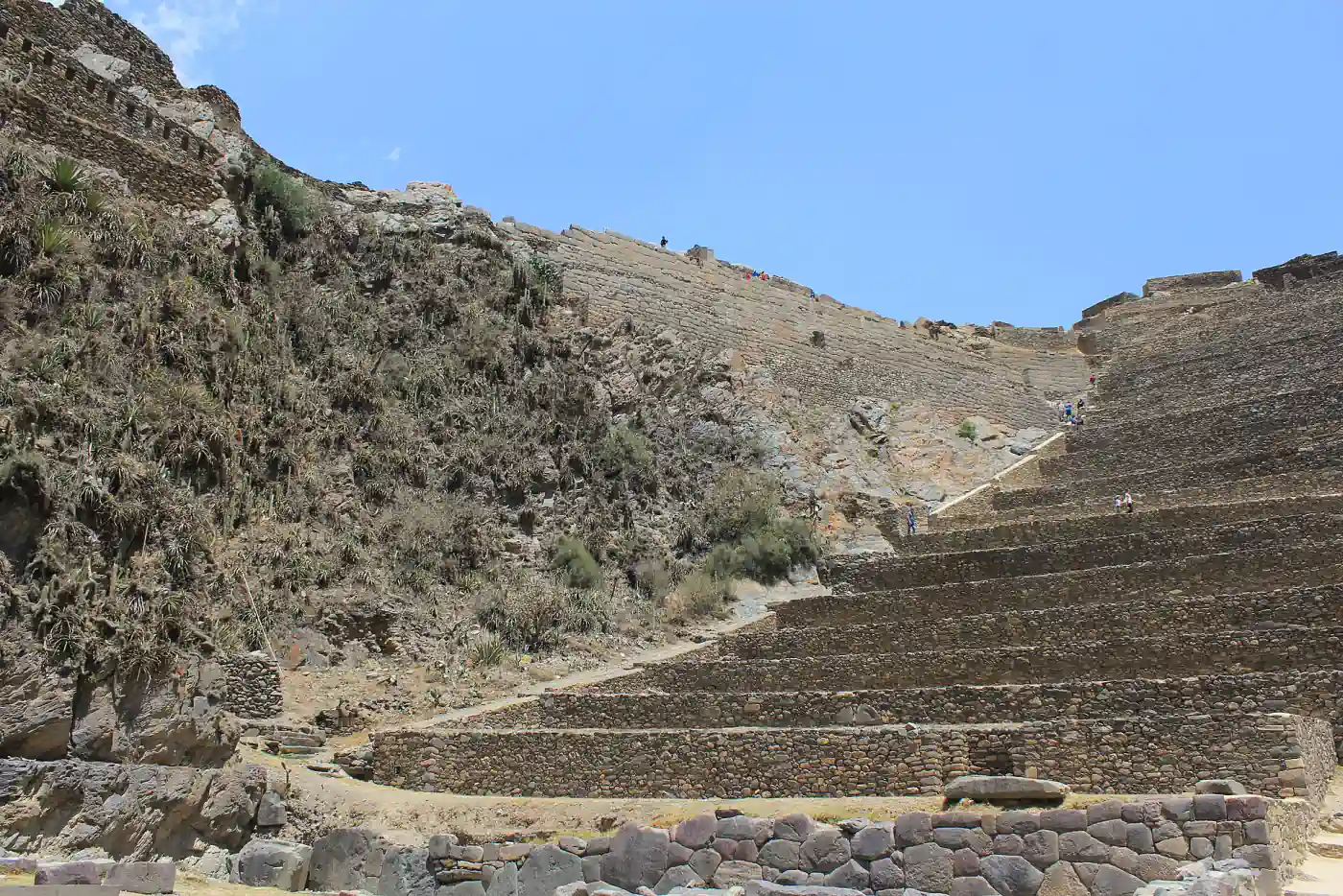 Inca terraces and stone walls climbing the hillside at Ollantaytambo, Peru